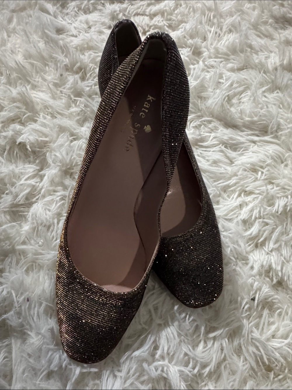 Kate Spade Dolores glitter block heels in a metallic silver and gold colorway.